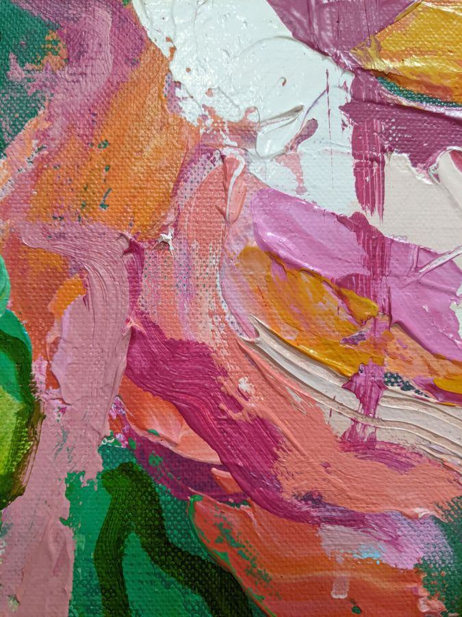 Close-up of pink, coral and teal paint strokes on canvas